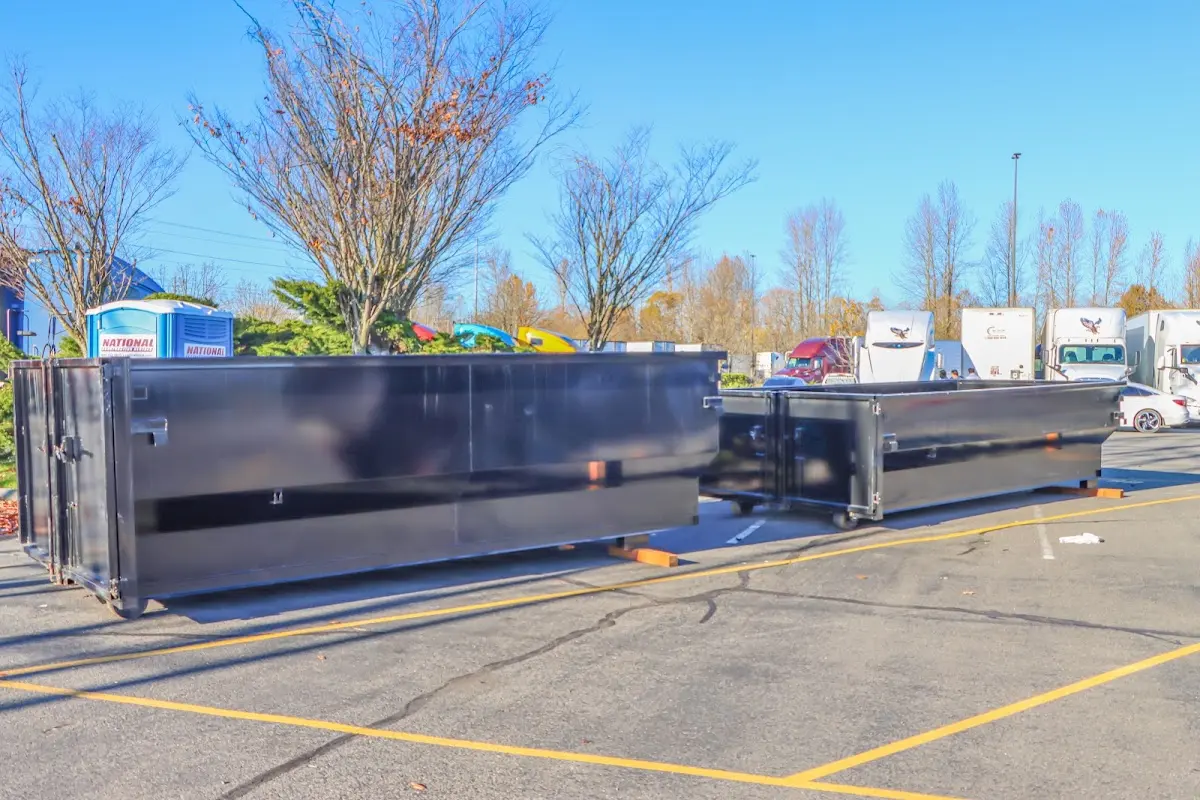 Professional dumpster rental service with roll-off container on residential driveway in Temescal Valley